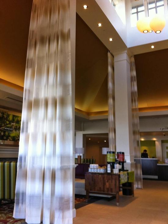 Hotel guest room with beds in front of blackout roller shade Toronto