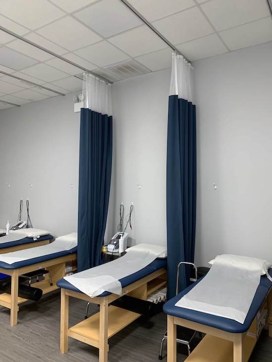 Blue hospital cubicle curtains separating beds